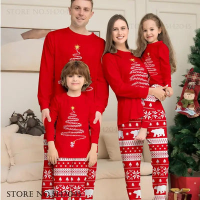 Family wearing matching red holiday pajamas featuring a Christmas tree design, perfect for the Holiday season.